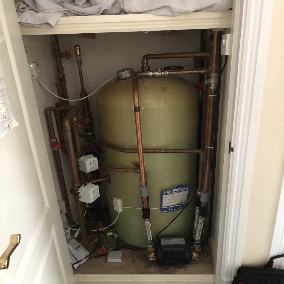 an old stored hot water cylinder in an airing cupboard