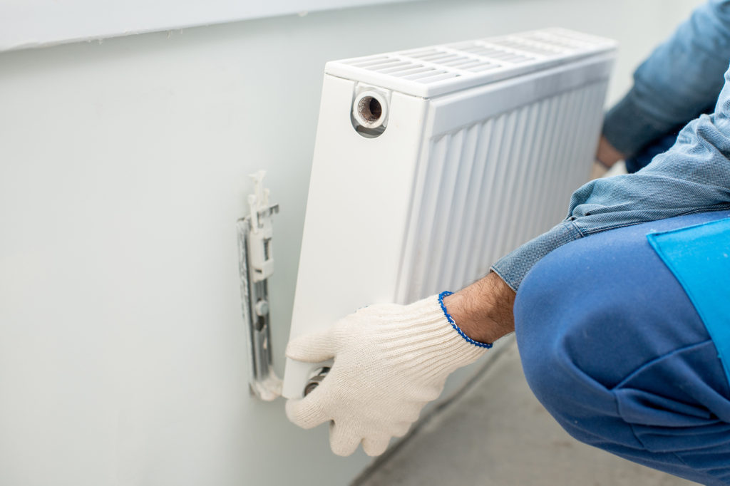 a painter is removing radiators to decorate a room