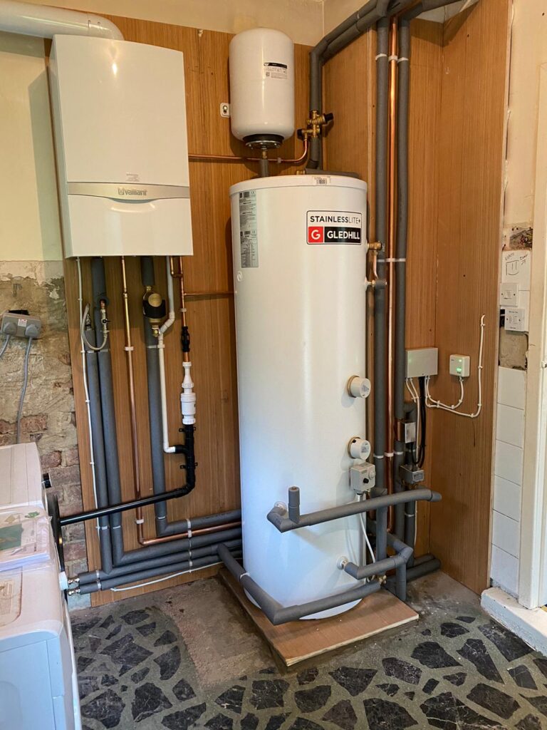 New Boiler in Yorkshire. Complete heating system fitted including Vaillant Ecotec Plus, Gledhill unvented cylinder with remote expansion vessel, system zone valves and wiring. all pipework clipped to plywood back and covered in pipe insulation where appropriate