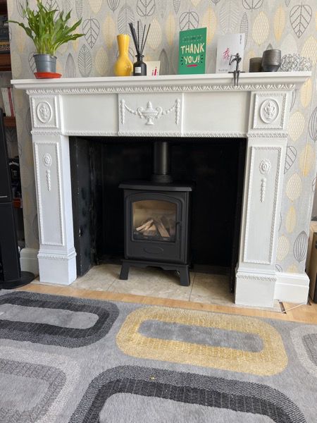 Stove in a fireplace project showing new Broseley Hereford 5 gas stove fitted in a white fireplace with black builders opening