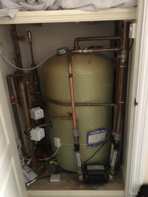 an old stored hot water cylinder in an airing cupboard