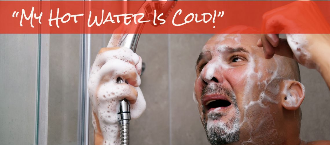My hot water is cold man standing in shower with soap over face looking at shower head