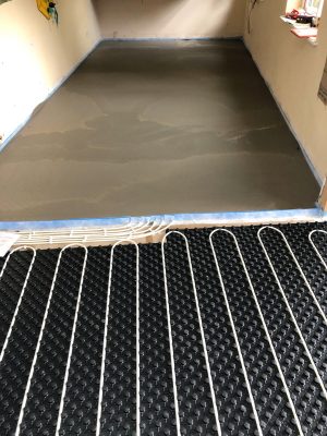 Screed in sections of nu-heat underfloor heating installation