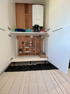 Parkstone Heating installation showing oiler, pipework, Solfex manifold and solfex underfloor heating boards