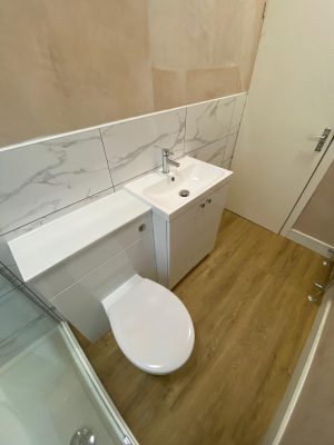 Narrow bathroom marble style tiles and Polyflor oak floor finish