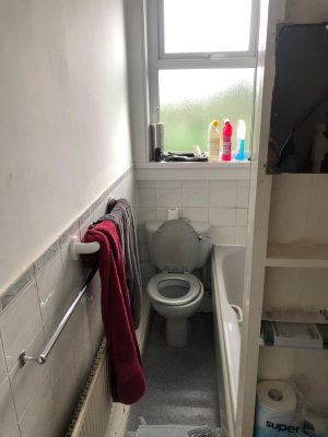 Old narrow bathroom with uncomfortable toilet position