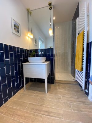 kitchen to bedroom conversion completed view of basin on table, lighting and entrace to concealed shower cubicle