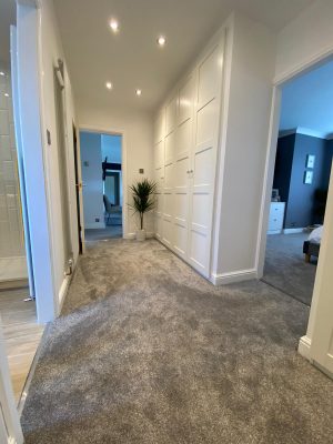 kitchen to bedroom conversion walk in wardrobe with luxury grey carpet and built in wardrobes