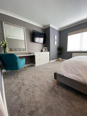 kitchen to bedroom conversion bedroom dressing table and luxury blue chair with large wall mirror and bedroom window