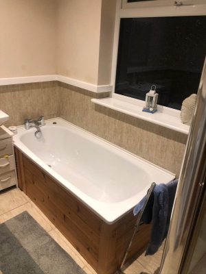 old bath with dark bath panel to be removed for upgrade