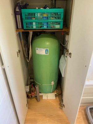 old indirect hot water cylinder in airing cupboard before upgrade to unvented hot water