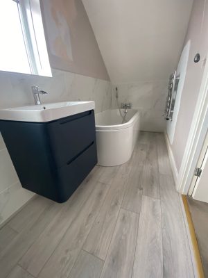 Bathroom refresh project in loft space with bath tucked under roof for more space.
