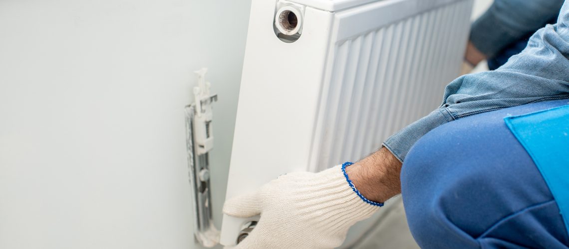 a painter is removing radiators to decorate a room