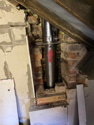 Dunsley Heat Advance 500 new liner installed in old chimney connected to stainless steel twin-wall chimney