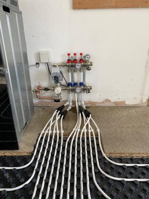 Nuheat LoPro Max manifold showing all flow and return pipes for underfloor heating