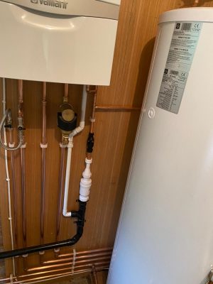 Complete heating system pipework under Vaillant Ecotec Plus boiler including filling loop, pressure relief termiation and condensate pipework. Magnetic filter fitted on return to boiler