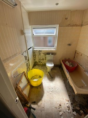 small bathroom renovation beginning to rip out old bathroom suite and tiles.