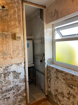small bathroom renovation removed boiler cupboard door and tiles removed from walls.