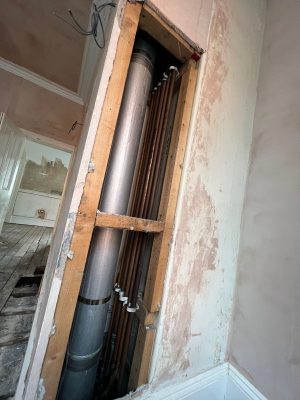 convert offices into a house project shows ducting containing all rising pipework from cellar