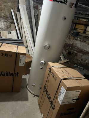 convert offices into a house project shows 300 litre Gledhill unvented cylinder and 2 Vaillant 618 system boilers and heating components delivered to cellar