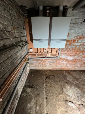 convert offices into a house project shows two Vaillant 618 system boilers connected with joint flow and return, condensate pipe and gas pipe